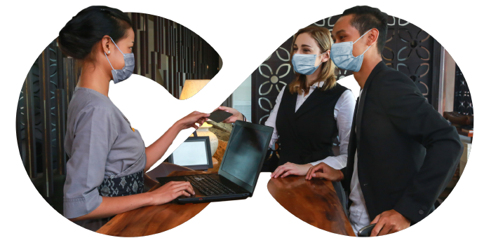 Image showing a couple wearing masking checking in at a hotel using Everlink technology to allow maximum social distancing.